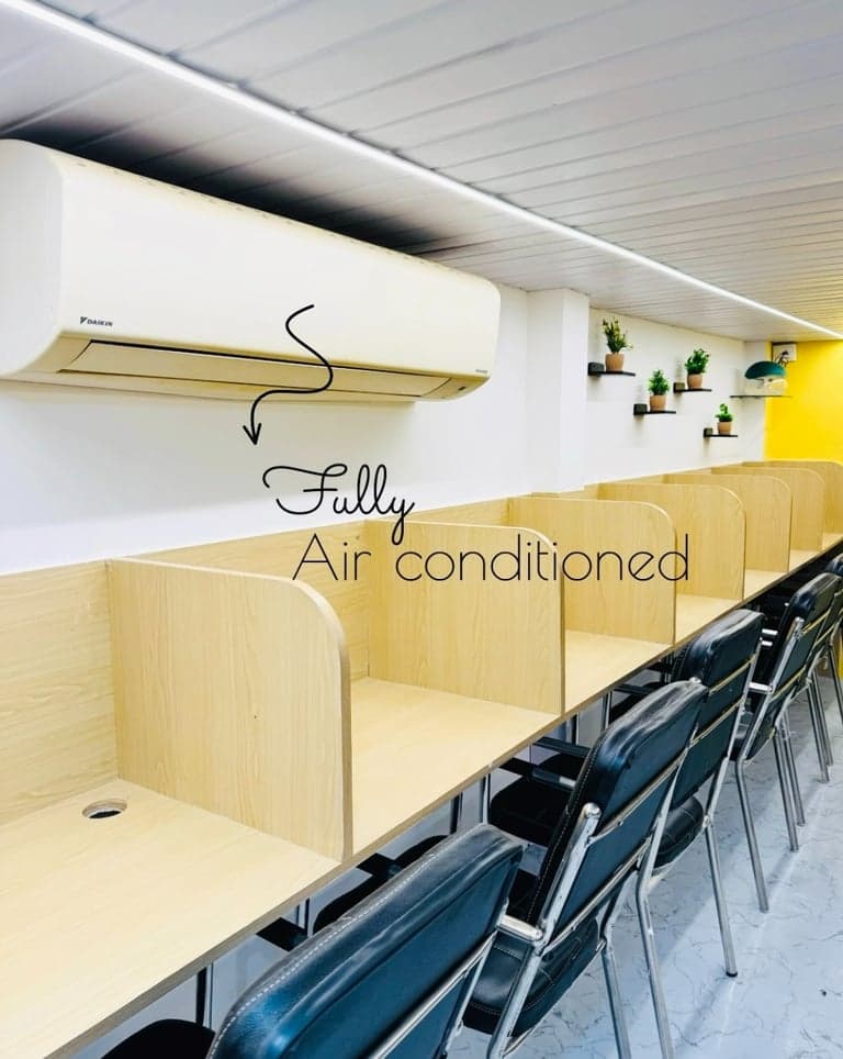 Individual study cubicles with warm desk lighting at The Study Corner, Lalbaug