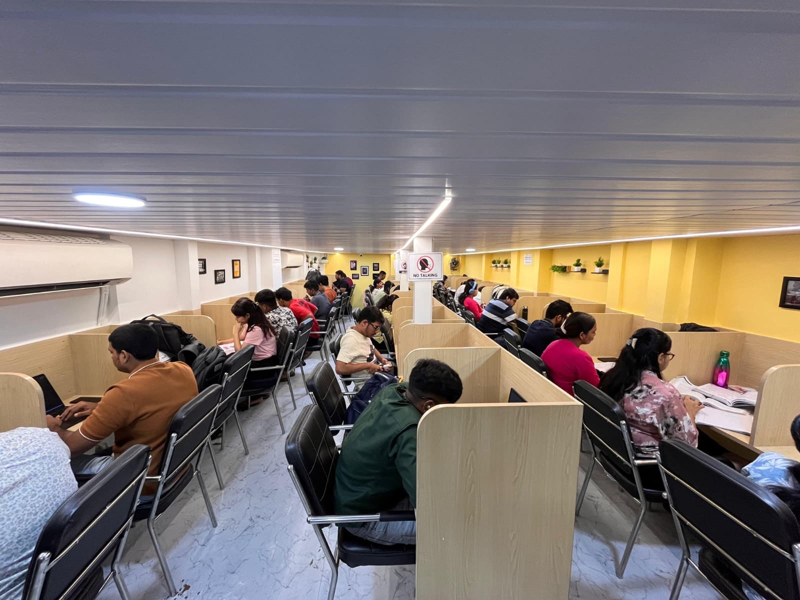 Students studying in the fully occupied silent study hall at The Study Corner, Lalbaug